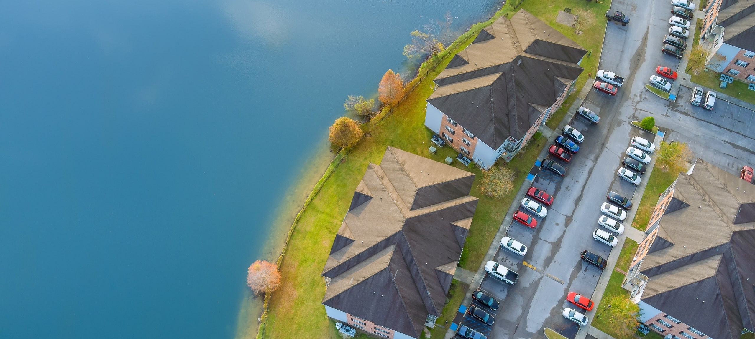 Aerial autumn scene the Denham Springs small town apartment complex near pond in Louisiana, US